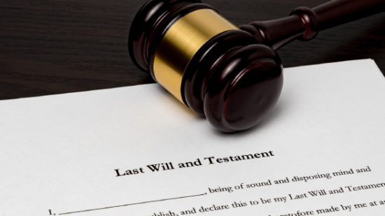 Last will and testament with gavel. Concept of planning for death, final wishes, probate court system, guardianship, inheritance tax and terminal illness.