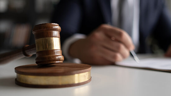 Judge or Legal advisor lawyer examining and signing legal documents.